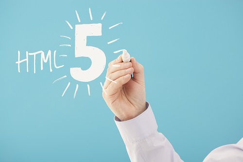 hand writing HTML 5 on glass